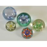 A group of five assorted paperweights, comprising; a red ground millefiori weight, 6cm diameter, and