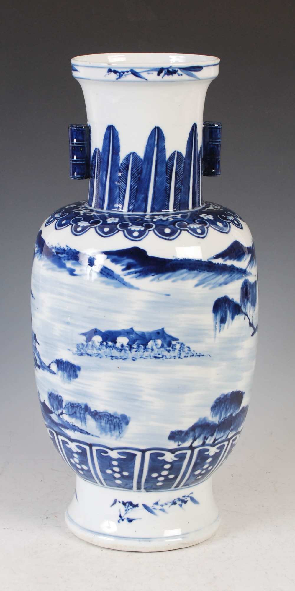 A Chinese blue and white porcelain arrow vase, late Qing Dynasty, decorated with pavilions and