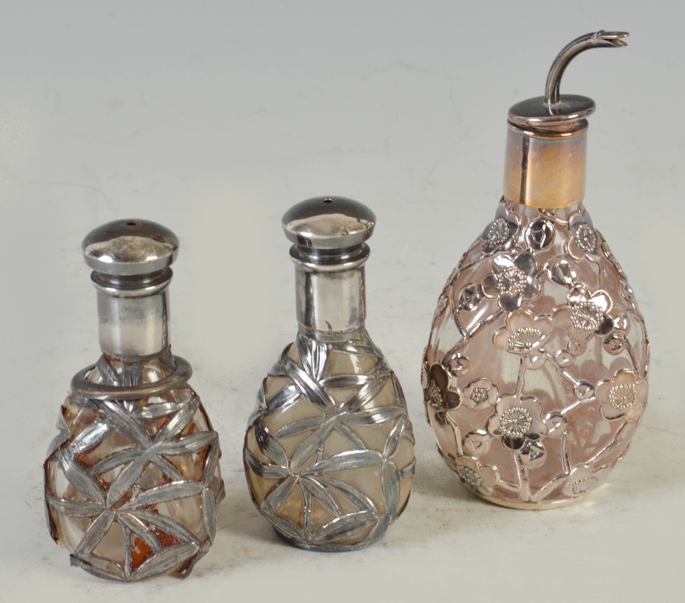 An early 20th century Chinese sterling silver mounted perfume or scent bottle with pouring