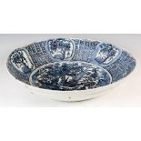 A Chinese porcelain blue and white dish in the Ming style, decorated with a circular shaped panel