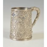 A Chinese silver export mug, late 19th century, decorated with berries and leaves, with bark