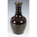 A Chinese porcelain famille noir monochrome bottle vase, the neck with horizontal ribs, 31.5cm