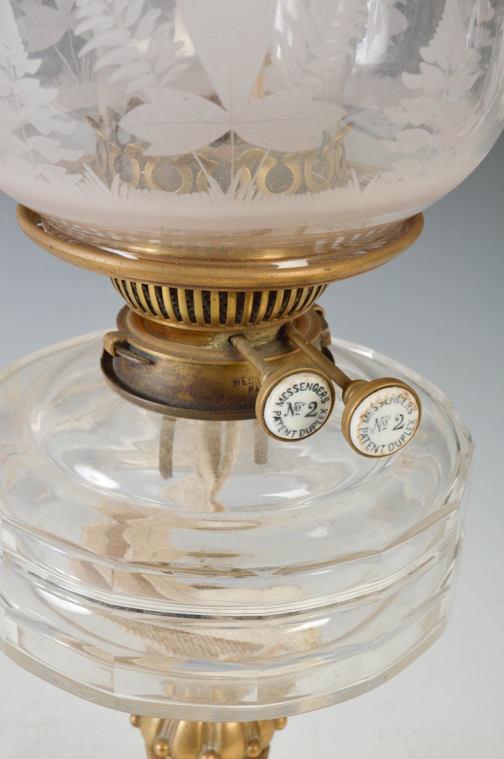 A late 19th/ early 20th century brass oil lamp, with cranberry and clear etched glass shade, with - Image 2 of 3