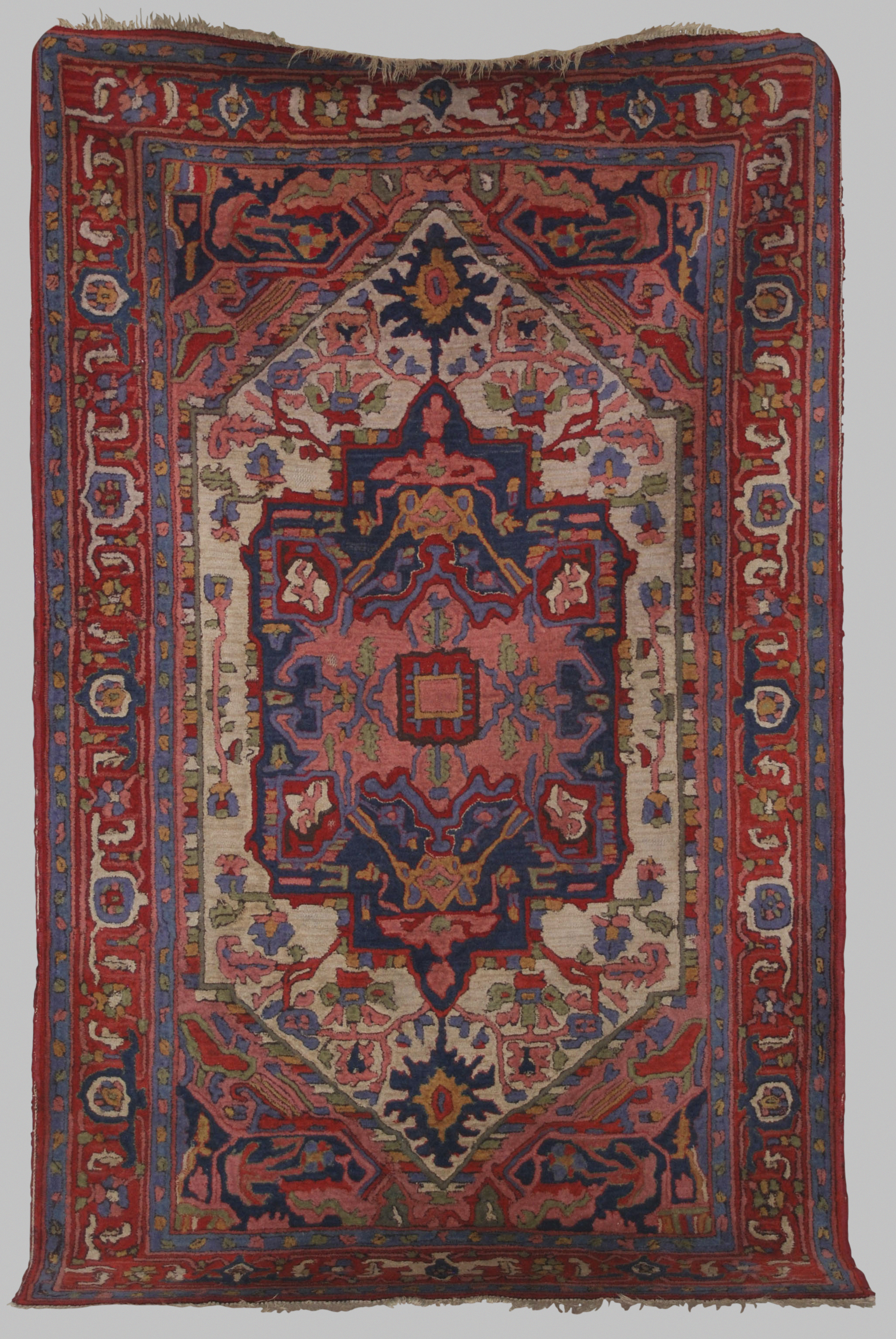 A Persian rug, 20th century, the rectangular field centred with a blue ground medallion within a