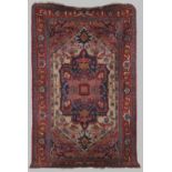 A Persian rug, 20th century, the rectangular field centred with a blue ground medallion within a