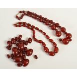 A group of red amber type beads, comprising; a graduated sphere shaped bead necklace,