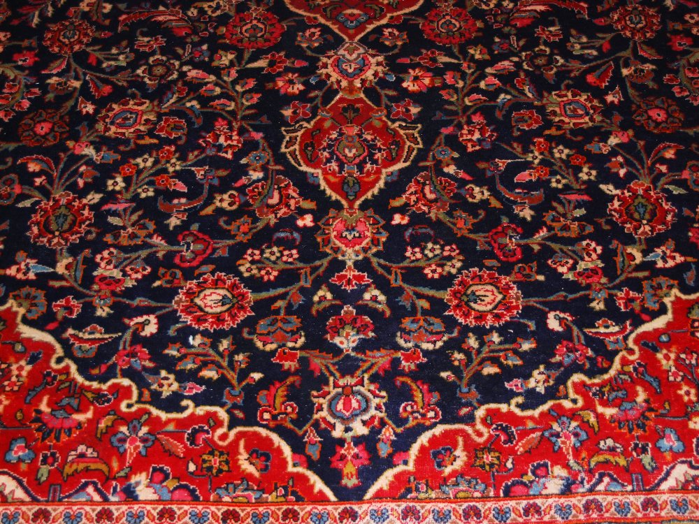 A Persian carpet, Kashan, 20th century, the rectangular blue ground field centred with an oval- - Image 5 of 8