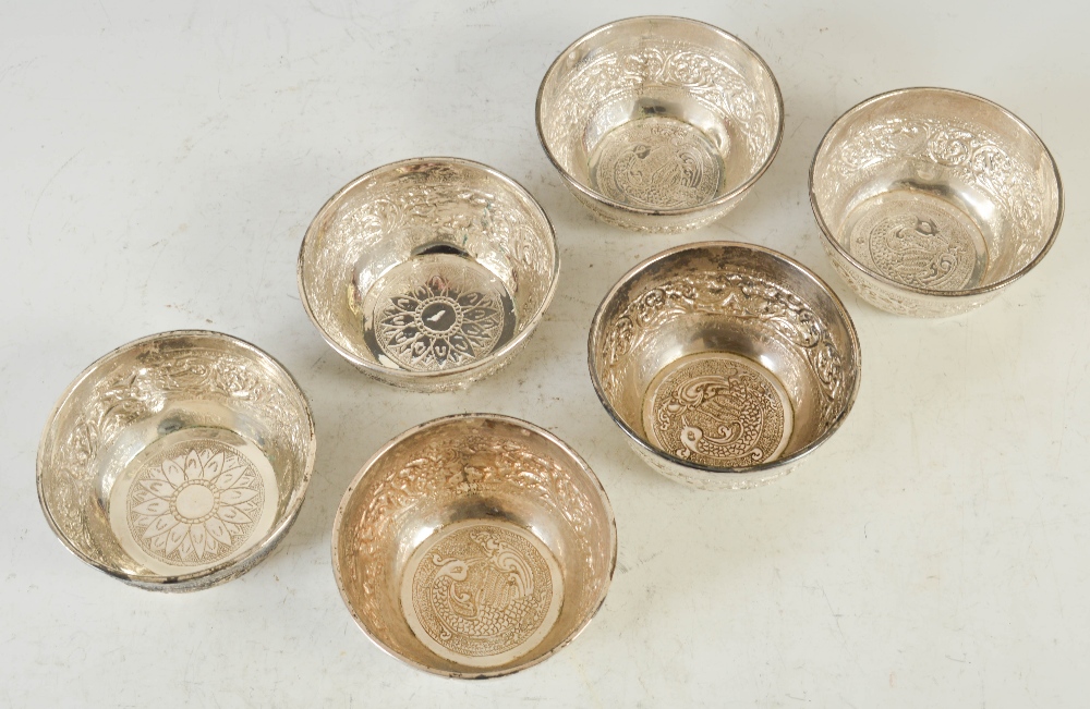 A set of six late 19th/ early 20th century Indian silver finger bowls, with embossed decoration of - Image 2 of 3