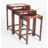 A nest of three Chinese dark wood occasional tables, late 19th/ early 20th century, the