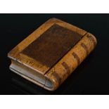 A 19th century novelty two-colour treen snuff box in the form of a book, with moveable spine and