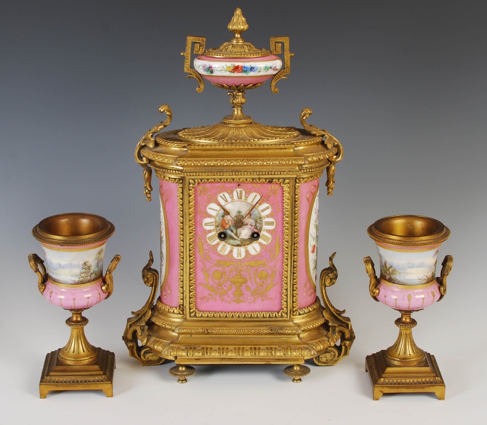 A 19th century ormolu and pink ground porcelain mounted clock garniture, the porcelain dial