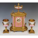 A 19th century ormolu and pink ground porcelain mounted clock garniture, the porcelain dial