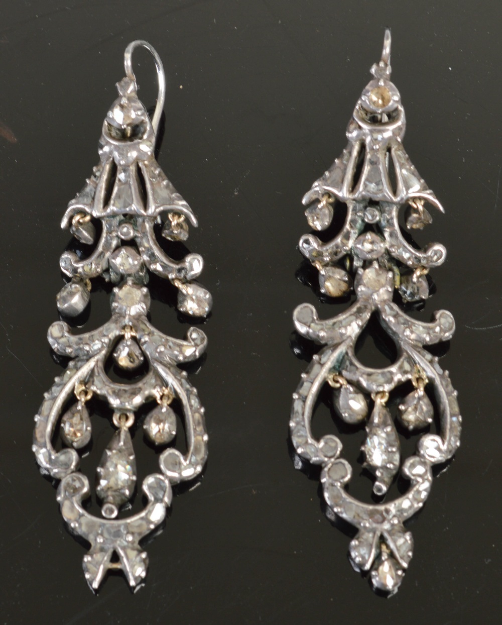 A pair of 18th century white metal and diamond set drop earrings, each of scrolling openwork