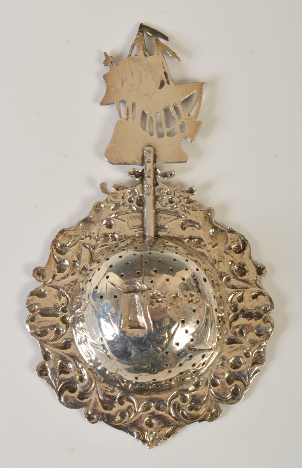 A 19th century Dutch white metal tea strainer, the handle formed as a pieced three masted galleon, - Image 2 of 3