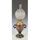 A late 19th/ early 20th century pottery oil lamp, the clear and frosted glass shade of lobbed form