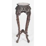 A Chinese darkwood jardiniere stand, Qing Dynasty, the octagonal top with a marble insert above a