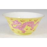 A Chinese porcelain yellow ground dragon bowl, Qianlong seal mark but later, decorated with two pink