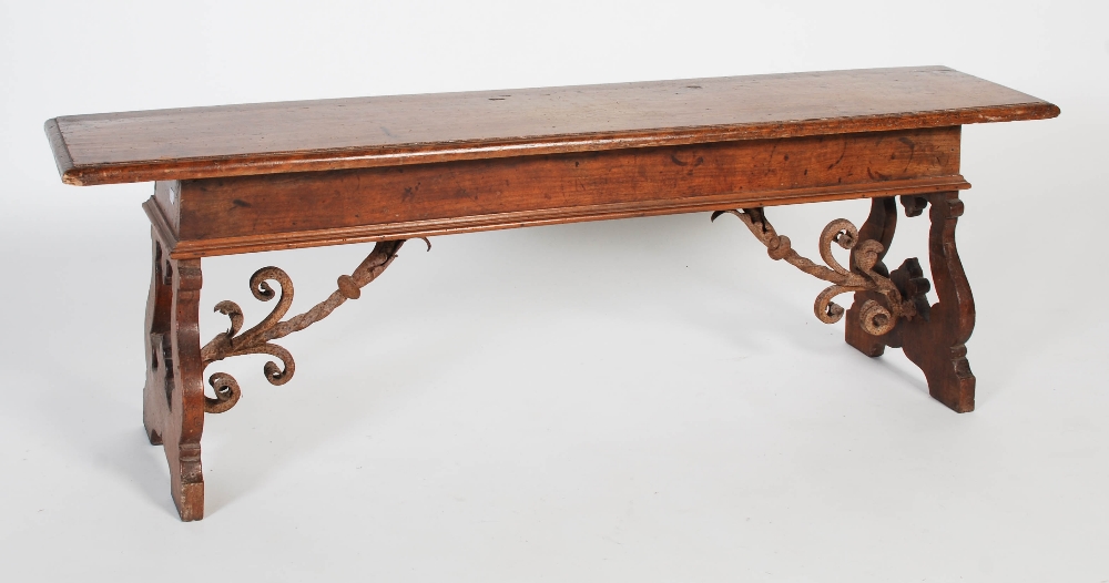 A Spanish walnut bench, probably 17th century and later, the rectangular planked top with moulded