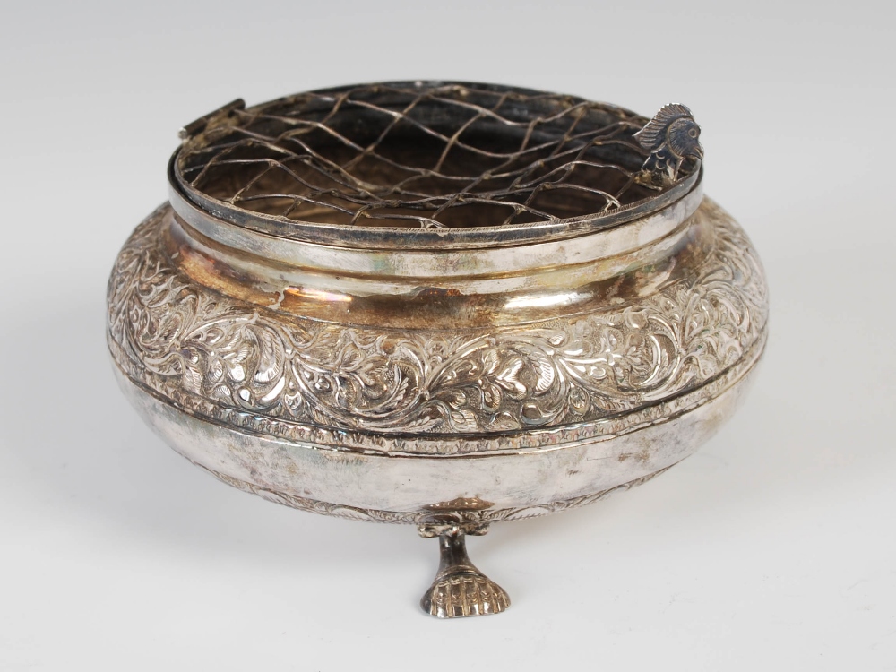 A Middle Eastern white metal rose bowl, the hinged grill with bird head thumb piece, with engraved