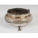 A Middle Eastern white metal rose bowl, the hinged grill with bird head thumb piece, with engraved