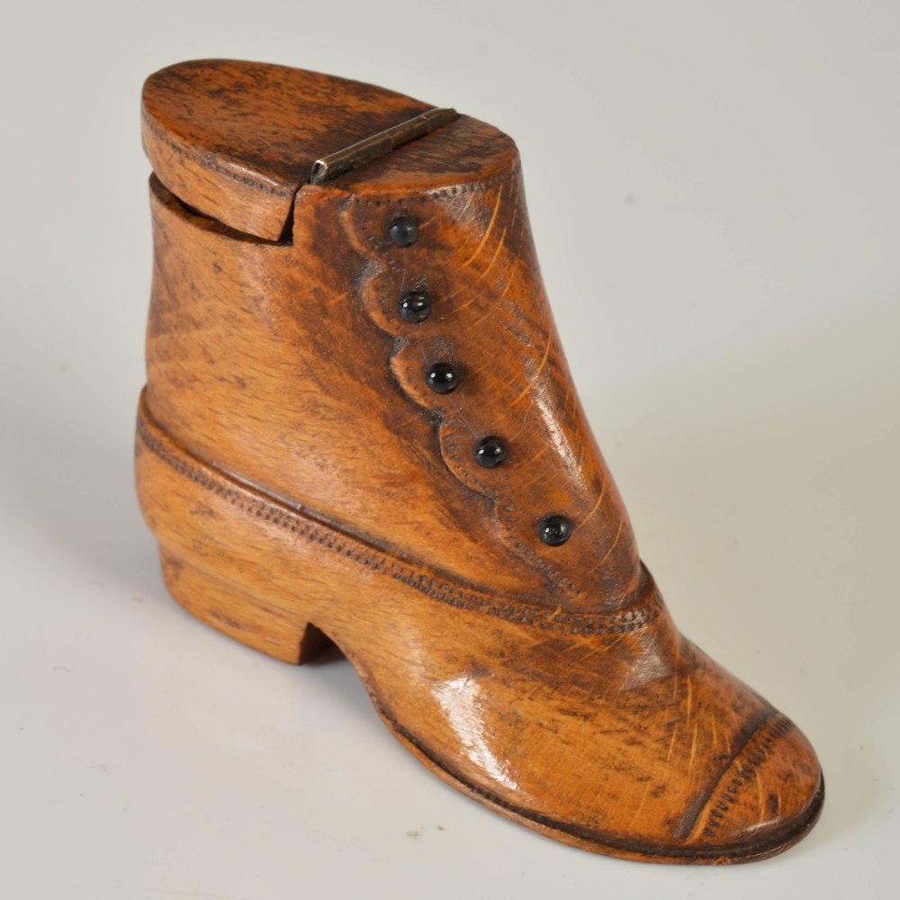 An early 19th century novelty treen snuff box carved in the form of a boot, with five stained