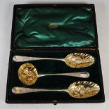 A cased set of three George III silver gilt berry spoons, London, comprising two berry spoons, 1782,