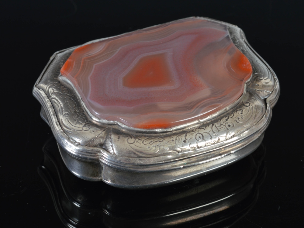 A George II silver cartouche-shaped snuff box, with russet banded agate-set lid within engraved