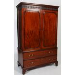 A 19th century mahogany linen press, the moulded cornice and fluted frieze with anthemion carved