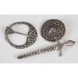 Alexander Ritchie, three silver and white metal brooches, comprising; a silver targe shaped brooch