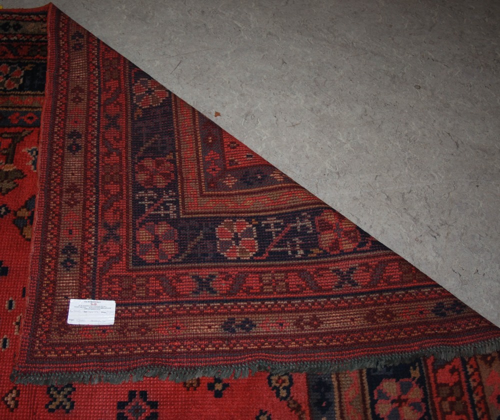 A late 19th/ early 20th century Ushak carpet, the madder ground decorated with flowers and - Image 3 of 8