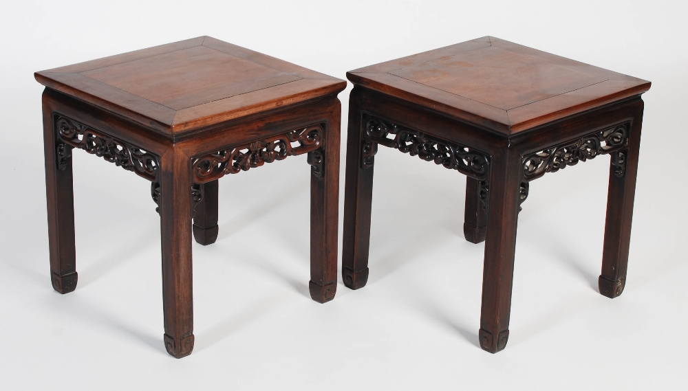 A pair of Chinese darkwood jardiniere/ urn stands, late 19th/ early 20th century, the square panel