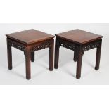 A pair of Chinese darkwood jardiniere/ urn stands, late 19th/ early 20th century, the square panel