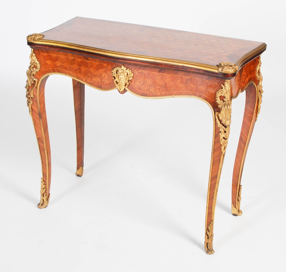 A late 19th/ early 20th century rosewood, parquetry and gilt metal mounted games/ card table, the