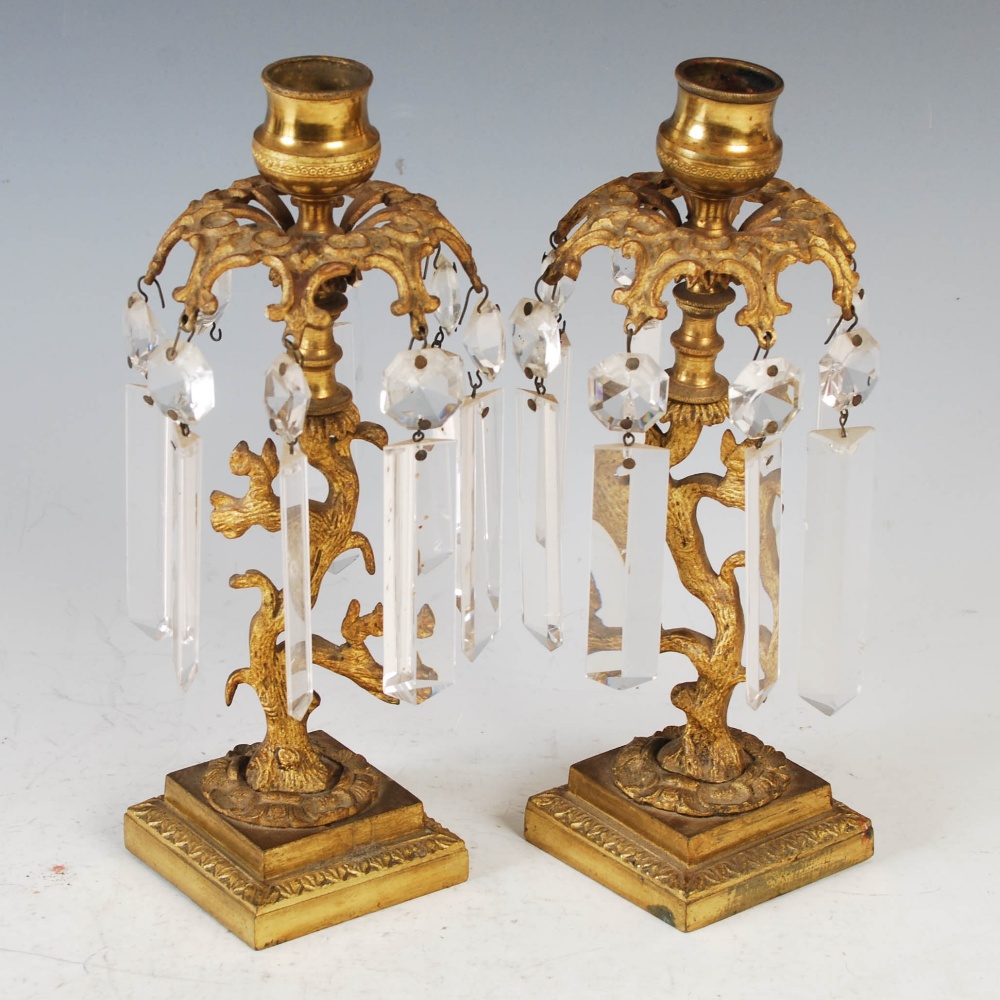 A pair of early 19th century gilt metal and cut glass lustre candlesticks, 23cm high.