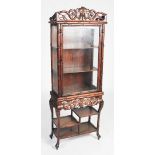 A Chinese darkwood display cabinet, late 19th/ early 20th century, the upper section with glazed