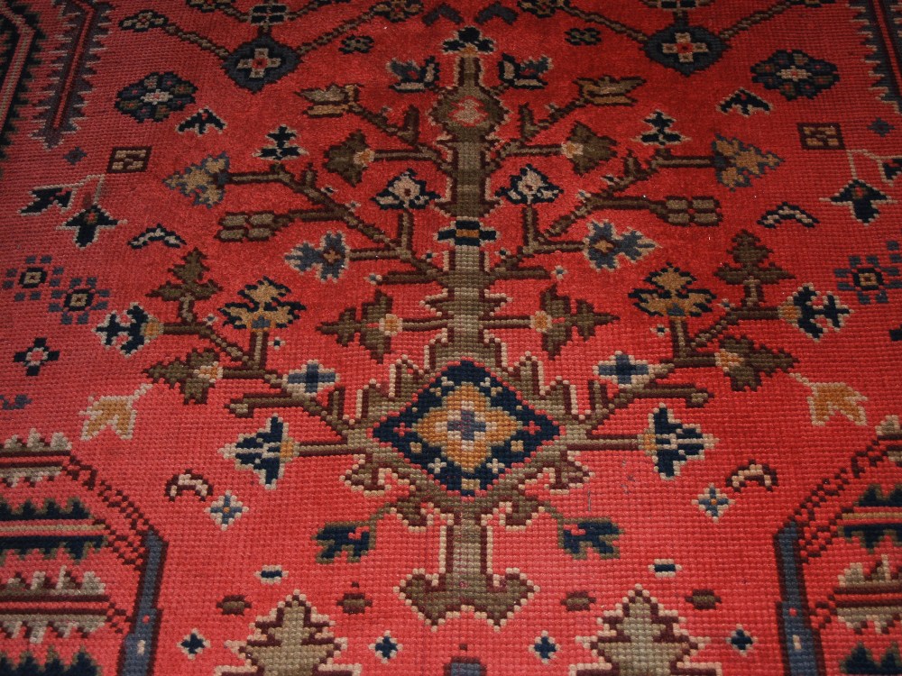 A late 19th/ early 20th century Ushak carpet, the madder ground decorated with flowers and - Image 5 of 8