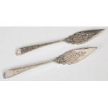 A pair of Victorian silver butter knives, Edinburgh, 1881, makers mark of WM, with engraved scroll
