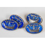 A pair of silver and blue enamel cufflinks after a design by Alexander Ritchie, the oval shaped