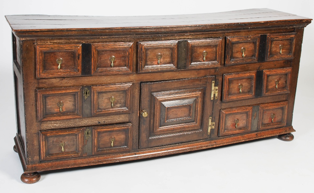 An 18th century oak dresser, the rectangular planked top above three frieze drawers and central