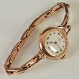 An early 20th century ladies 9ct gold cased Rolex wristwatch, the white enamel dial with red and