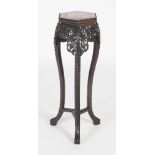 A Chinese darkwood jardiniere stand, Qing Dynasty, the hexagonal top with a marble insert above a