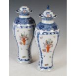 A pair of Chinese porcelain blue and white jars and covers, Qing Dynasty, decorated with rectangular