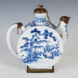 A Japanese blue and white porcelain gilt metal mounted tea pot, 19th century, circular shaped
