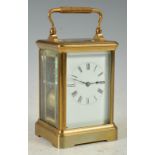 A late 19th/ early 20th century carriage clock, with black and white Roman numeral dial, the twin