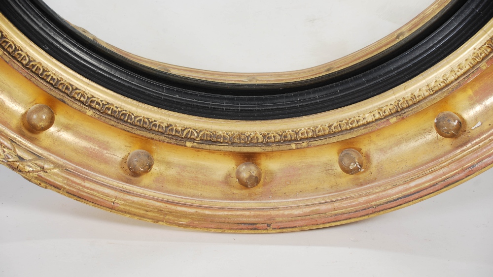 A 19th century giltwood mirror, the circular convex mirror plate within ball-set frieze, 58cm - Image 2 of 3