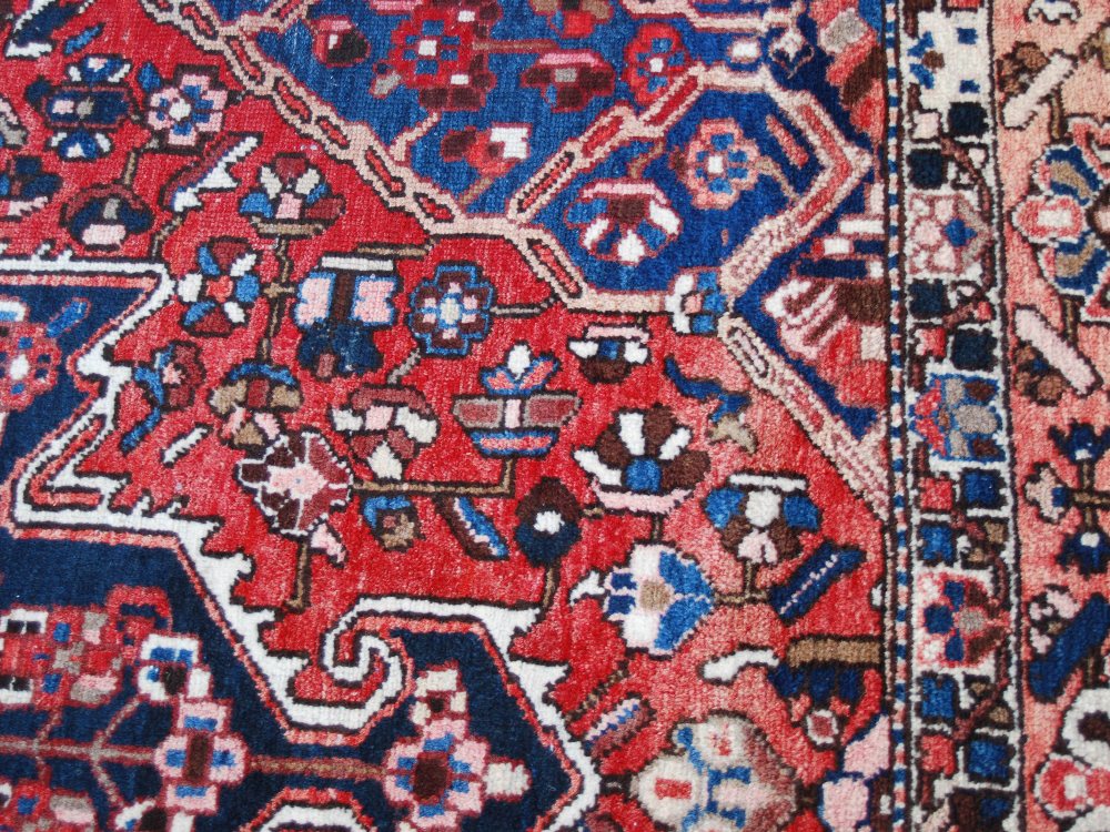 A Persian rug, 20th century, the rectangular field centred with a large open stylised flower - Image 7 of 8