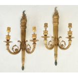 A pair of gilt metal Neoclassical style two-light wall sconces, 45.5cm long