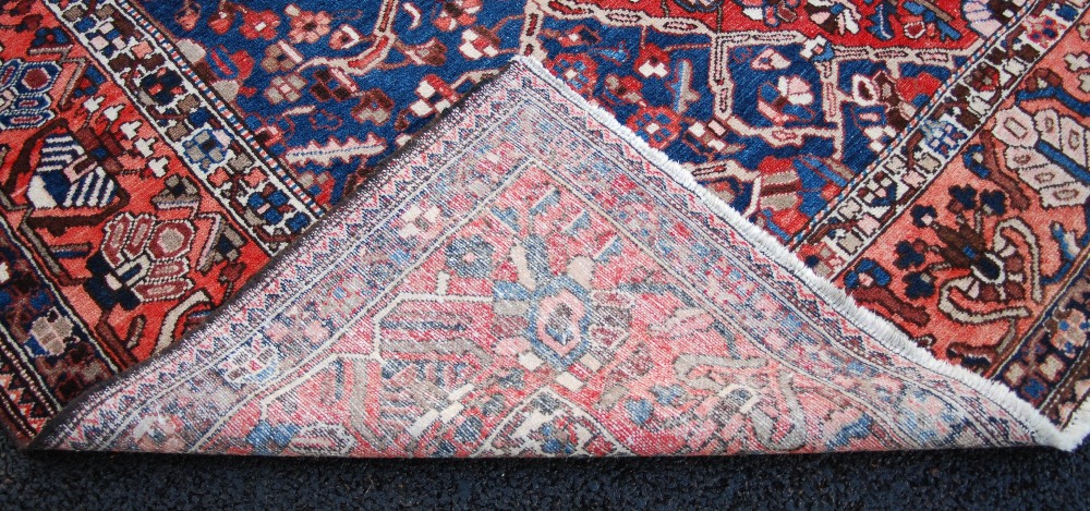 A Persian rug, 20th century, the rectangular field centred with a large open stylised flower - Image 4 of 8
