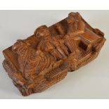 A mid 19th century 'blind man' table snuff box, the cover carved in high relief with a depiction