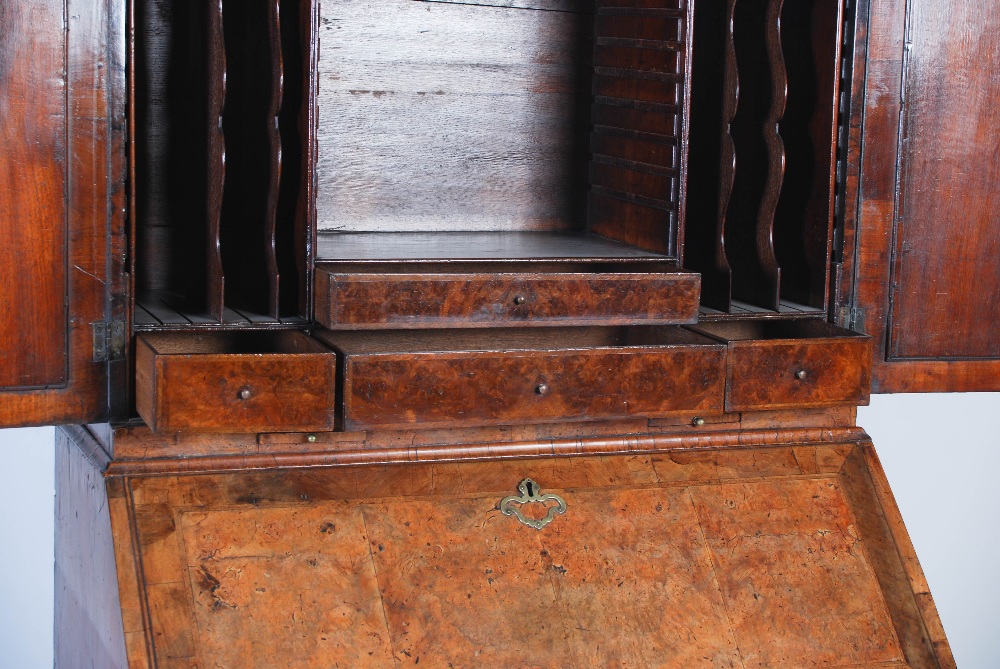 A George III walnut bureau bookcase, the moulded cornice above a pair of mirrored cupboard doors, - Image 11 of 14